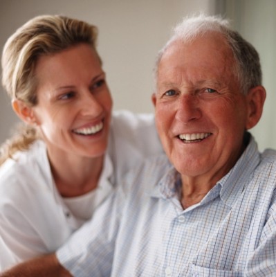 Closeup of a happy old man on the wheel chair with a nurse