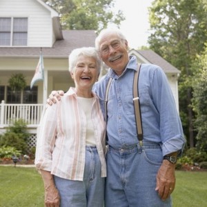 Couple standing in front of house