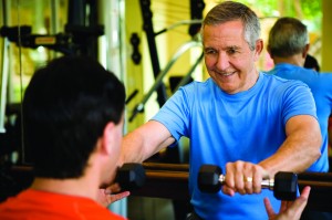 Senior man working with personal trainer