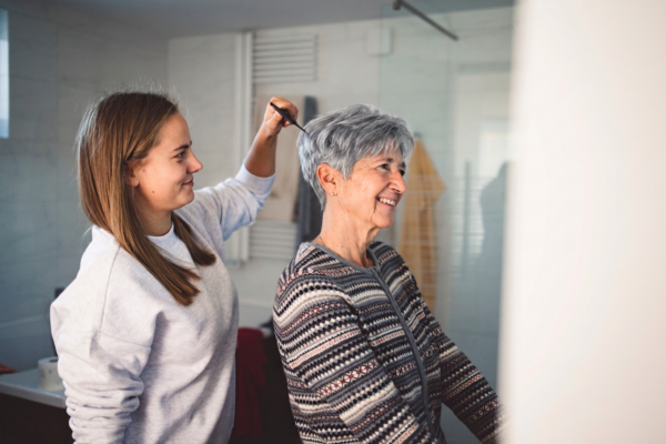 Caregiver helping a senior woman safely enter a bathroom for a bath visit in Chapel Hill North Carolina