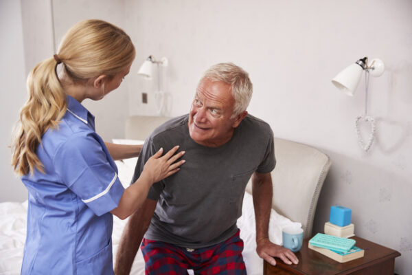 Caregiver assisting a senior stroke survivor with right side weakness in Apex Morrisville North Carolina